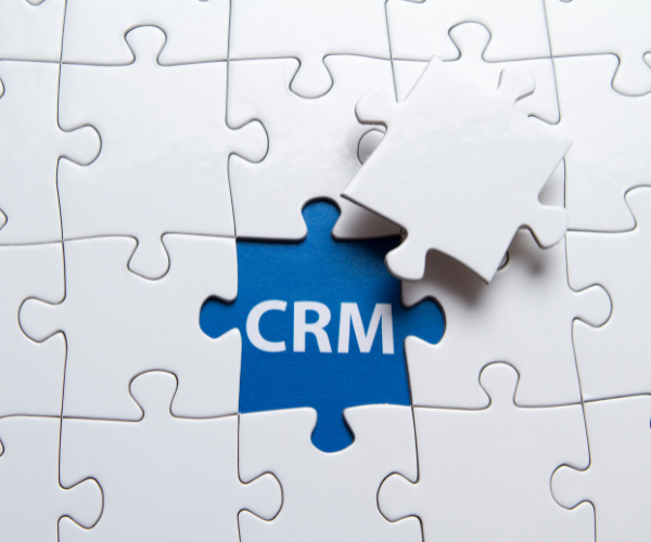 A piece of a puzzle reveals the word CRM