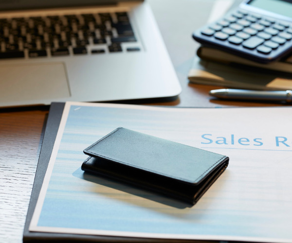 Homebuilder Sales Report on desk with laptop and calculator